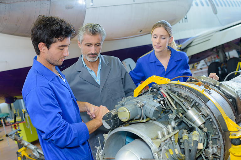 students and instructor working on machinery