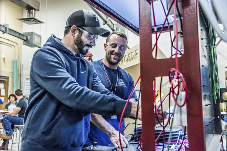 students working on electrical equipment