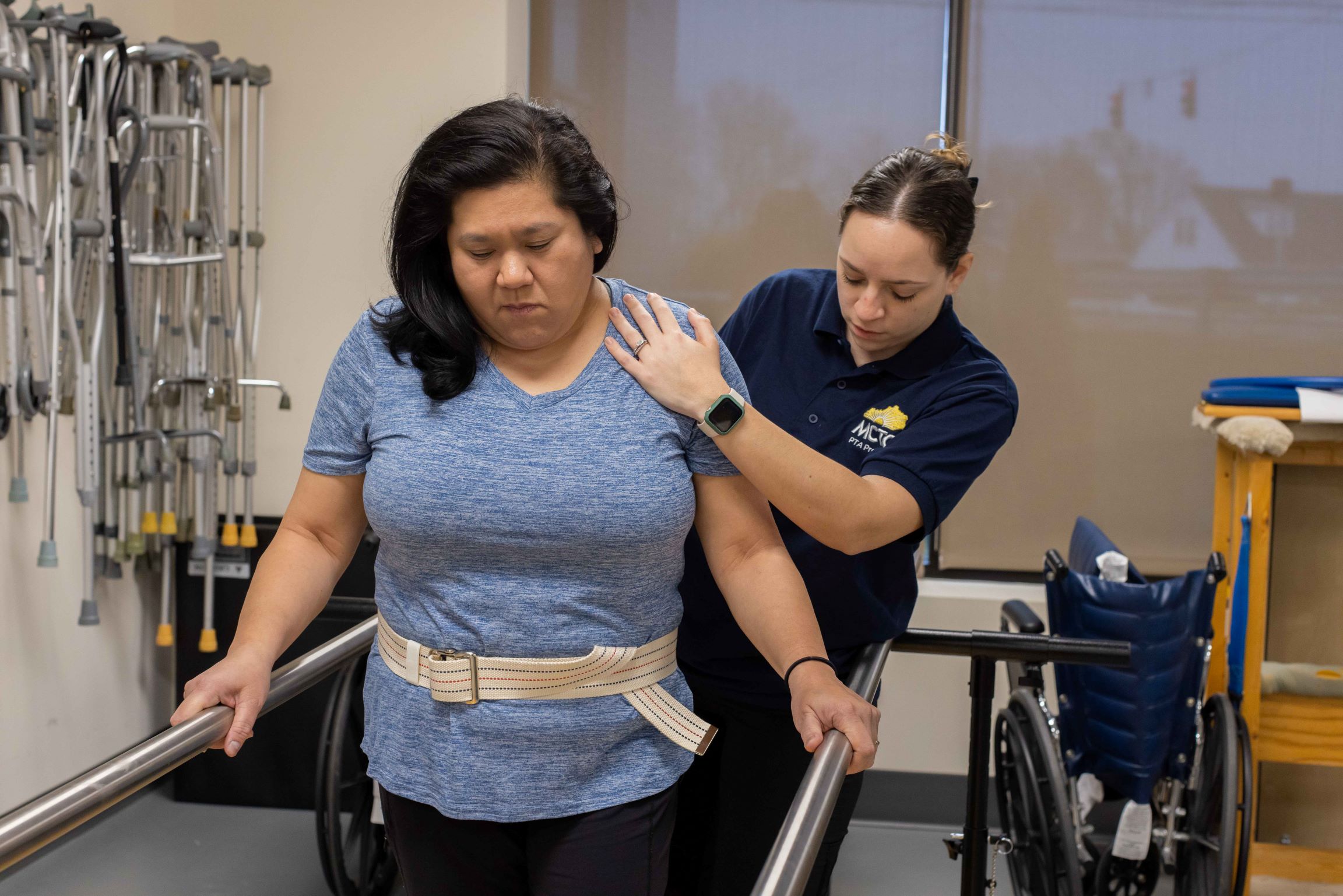 PTA student helping a woman