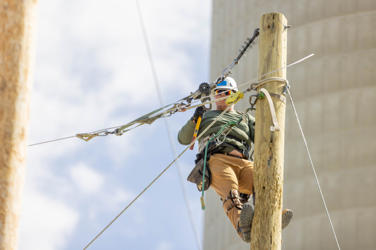 lineman up working on a telephone line