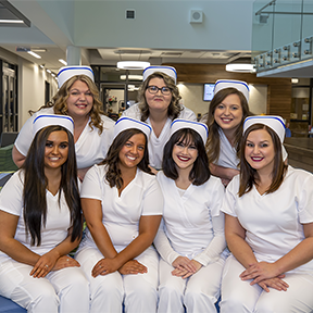 Group of female LPN students in their pinning uniforms - white scrubs.