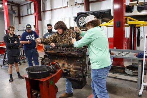 students moving an engine