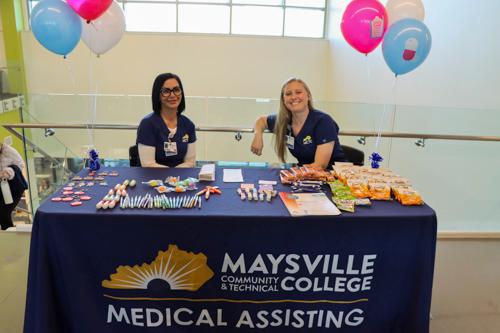 Two women sitting at the Medical Assisting table