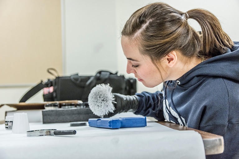 A criminal justice student examining forensic evidence