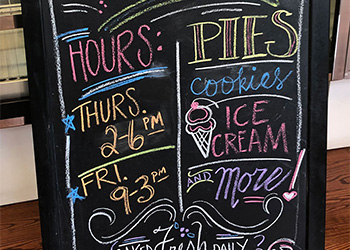 Hand drawn chalkboard sign for the college bakery.