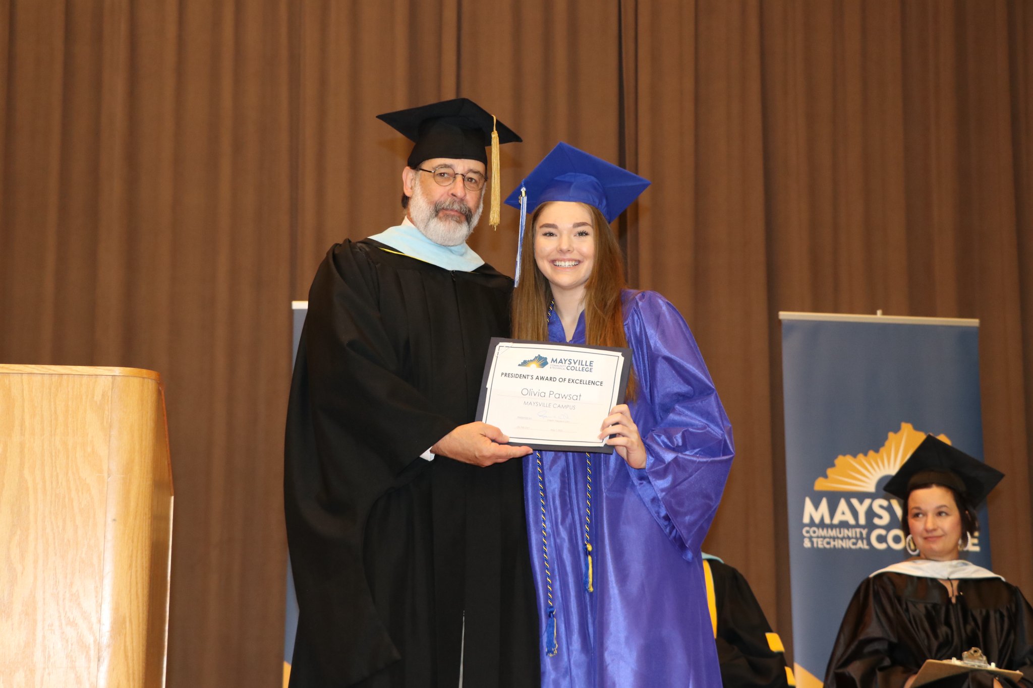 Maysville President's Award of Excellence Recipient Pawsat at graduation.