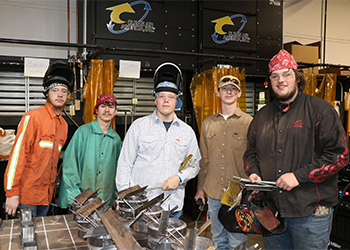 Five male welding students in the MCTC Rowan Campus welding lab during Trade Wars 2022 competition.