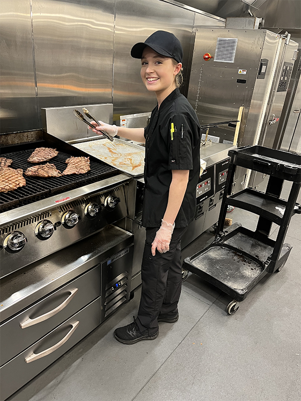 Student preparing steak at the Kentucky Derby.