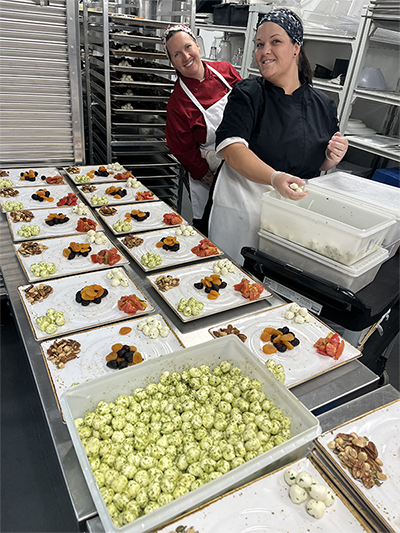 Students preparing large quantities of food at the Kentucky Derby.
