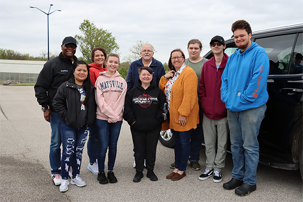 Culinary students and instructors standing together for photo before packing to leave for derby.