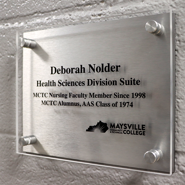 Plaque in honor of Debbie Nolder room naming.