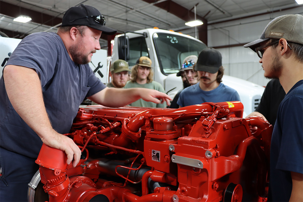 Instructor Preston Netherly showing students the new engine from Link-Belt.