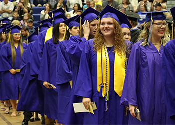 Students walking in at graduation.