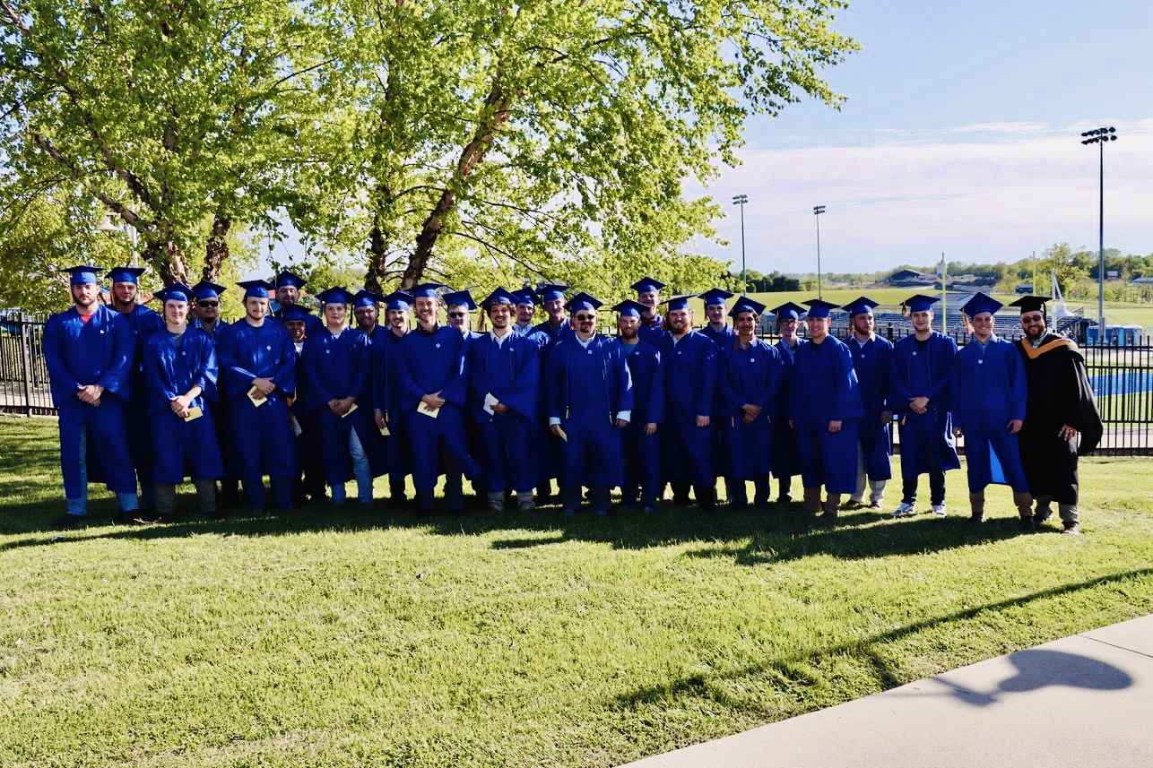 HVAC students graduating in their blue cap and gowns.