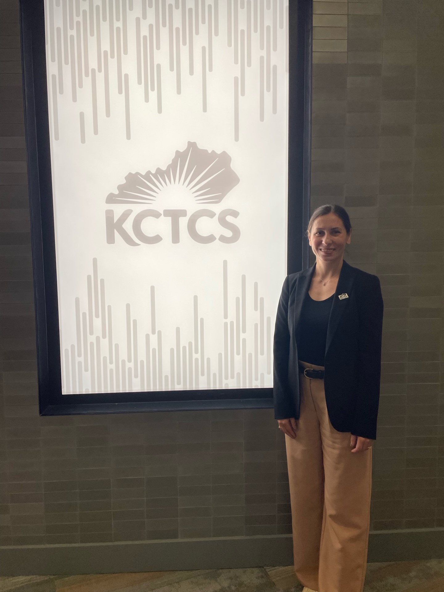 MCTC student Alexandra Martin standing with KCTCS signage.