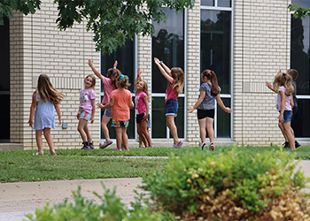 Children attending Kid's College playing outside at the Maysville Campus.