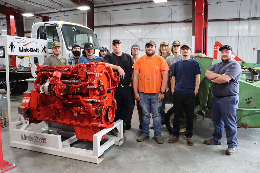 Students in Diesel technology lab at MCTC Rowan Campus standing with the new donated engine.