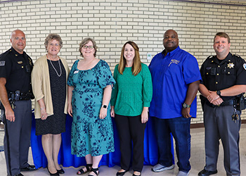 In photo from left, MPD Chief Michael Palmer; Mayor Debra Cotterill; Dr. Laura McCullough, MCTC President/CEO; Amanda Conley, Dean of Administrative Services; Chris Neal, Community Liaison; and MPD Assistant Chief, Chris Conley