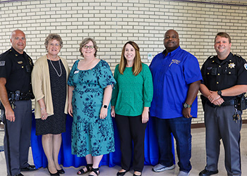 MCTC President and HR standing with City of Maysville Mayor and campus officers.