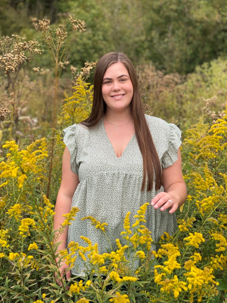 Avery Barnes surrounded by flowers