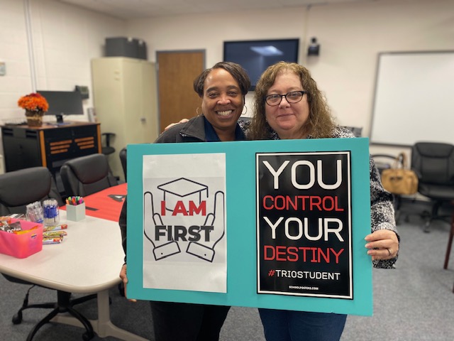 two women holding "You control your destiny" poster