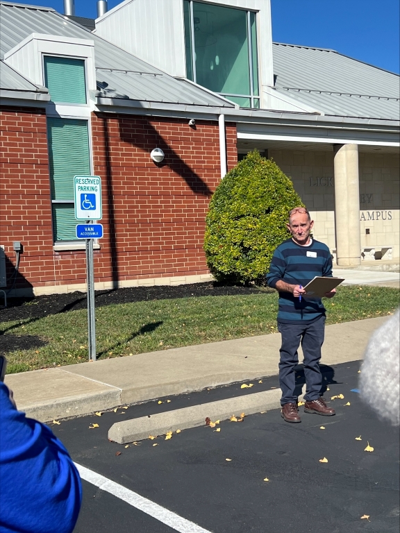 Jerry Napier with a clipboard in a parking lot