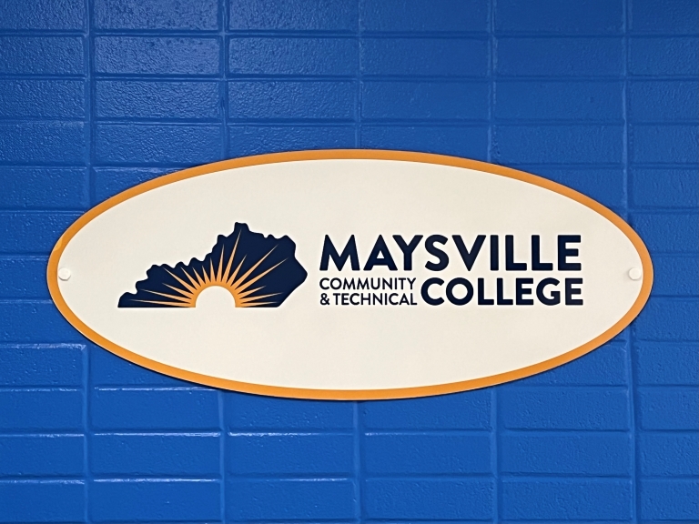 MCTC logo on a blue brick wall