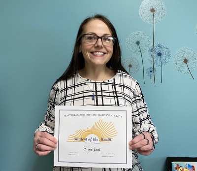 Carrie Jani holding her Student of the Month certificate