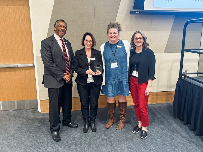 Dr. Dana Calland, Vice President of Academic Services, and Dr. Maggie Price, Director of Student Success, represented MCTC at the summit to accept the award. With them are Aaron Thompson and Lilly Massa-McKinley representing CPE.