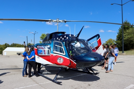 students looking at an EMS helicopter