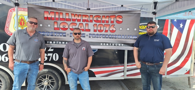 three men in front of a Millwrights Local 1076 sign