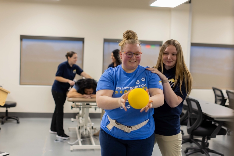 students practicing PTA techniques with a ball