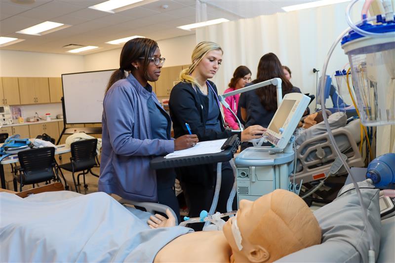 Respiratory Therapy students practicing their skills with a mannequin