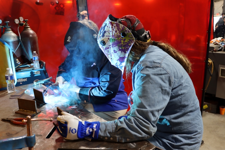 students welding at the Trade Wars event