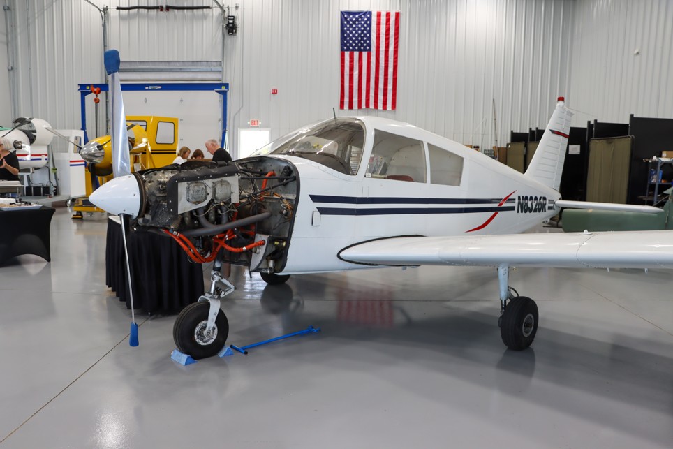 Small airplane with engine compartment open, parked in the MCTC Aviation Maintenance lab.