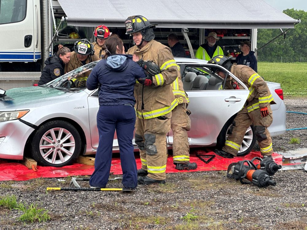 students participating in a crash simulation with local first responders