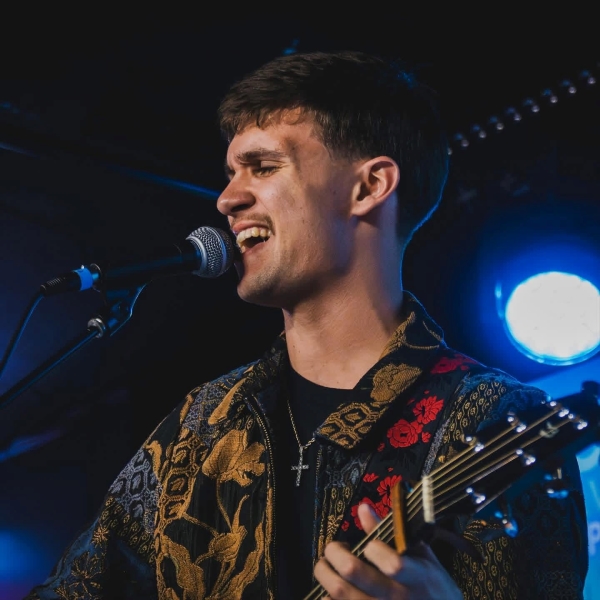 Hunter Jordan singing and playing guitar