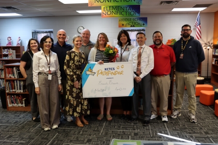 Brandi Brewer, the Director of Counseling, Instruction, and Food Service at AIS accepting the Pathfinder Award with a group of others